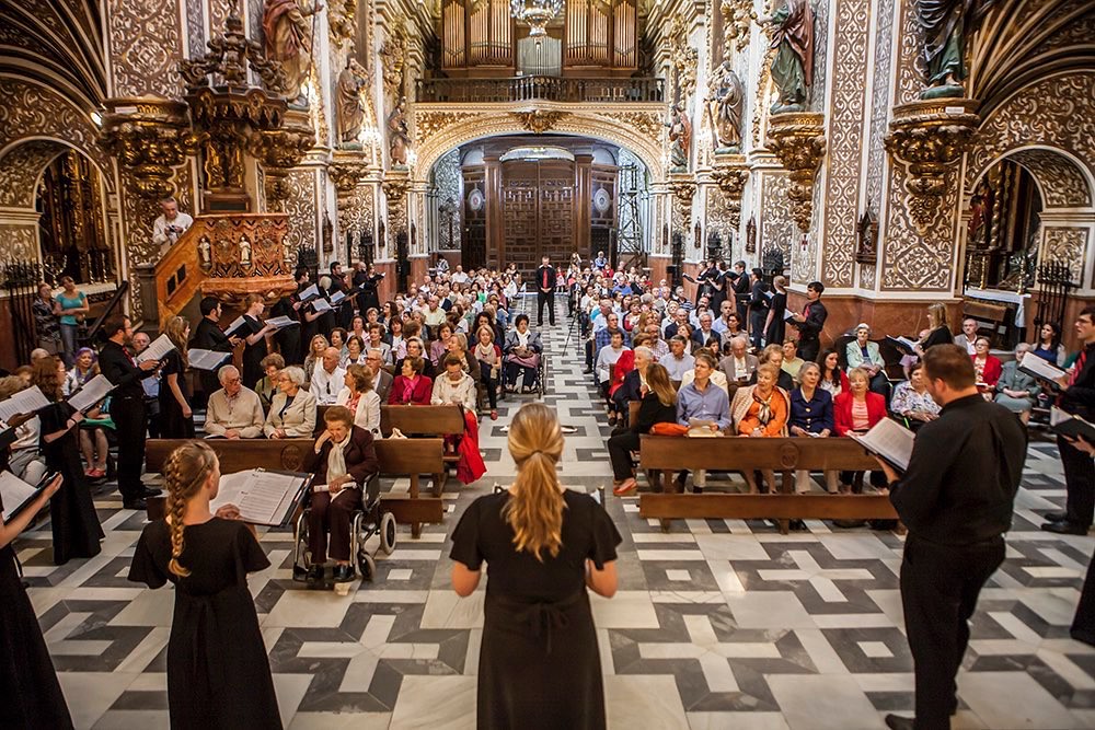 Choir performing to full audience in ornate church